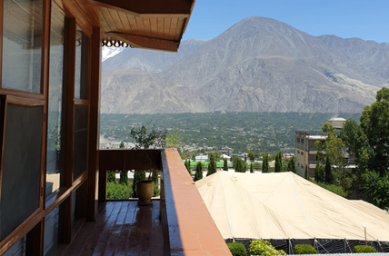 image taken from the balcony of an hotel in Pakistan that features the beautiful mountains and forest