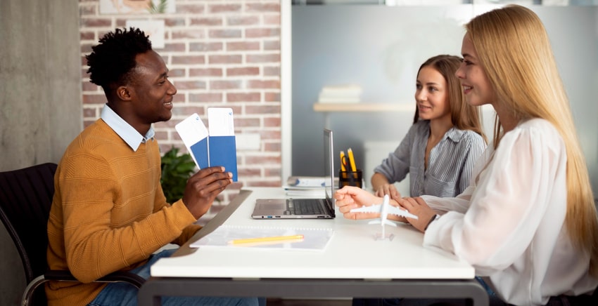 Travel agent talking to girls about their trip