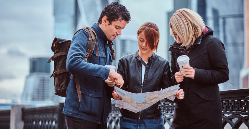 Tour guide and travelers discussing their destination