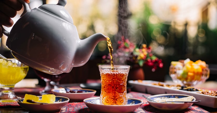 A man pouring tea in the cup